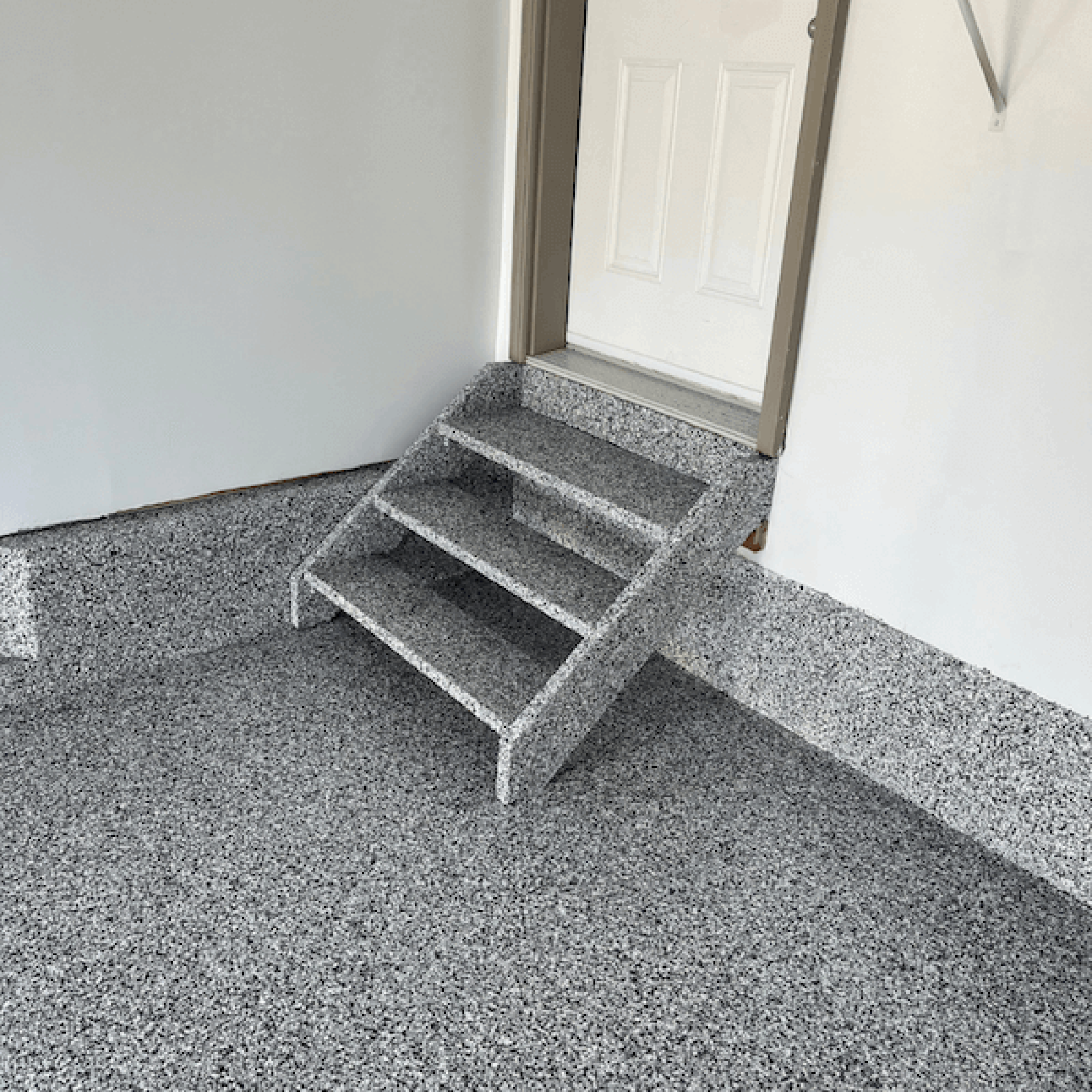 Garage floor coated in polyaspartic flooring by Pryce Designs