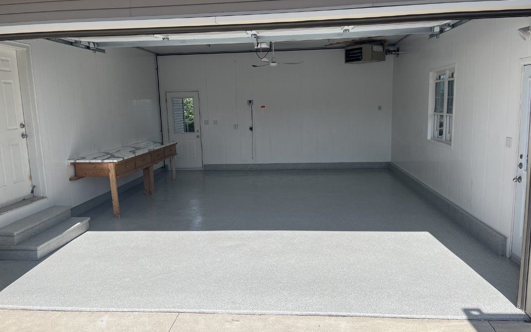 Garage floor coated in polyaspartic flooring by Pryce Designs