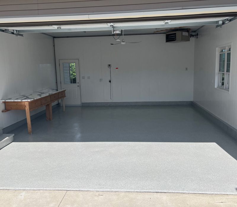 Garage floor coated in polyaspartic flooring by Pryce Designs